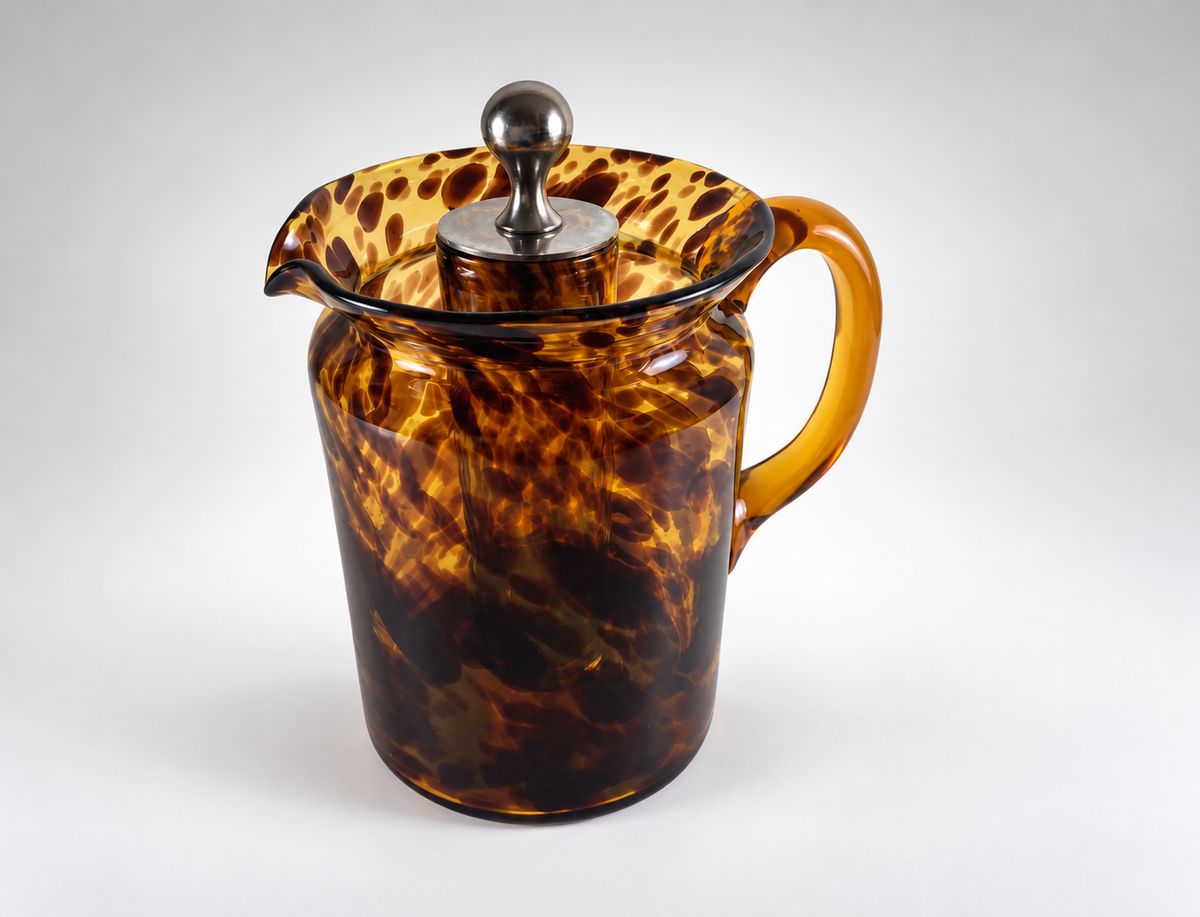 Christian Dior Home 1960s tortoiseshell glass pitcher showing internal ice chamber and chrome stopper
